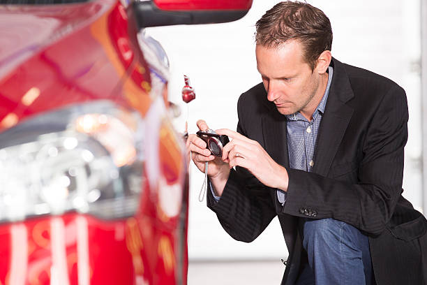 car appraisal officer examining a red car. make money with your car